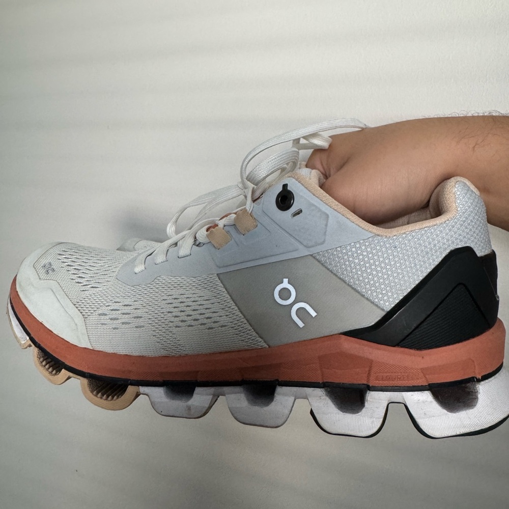 On Running White and Tan Athletic Shoes